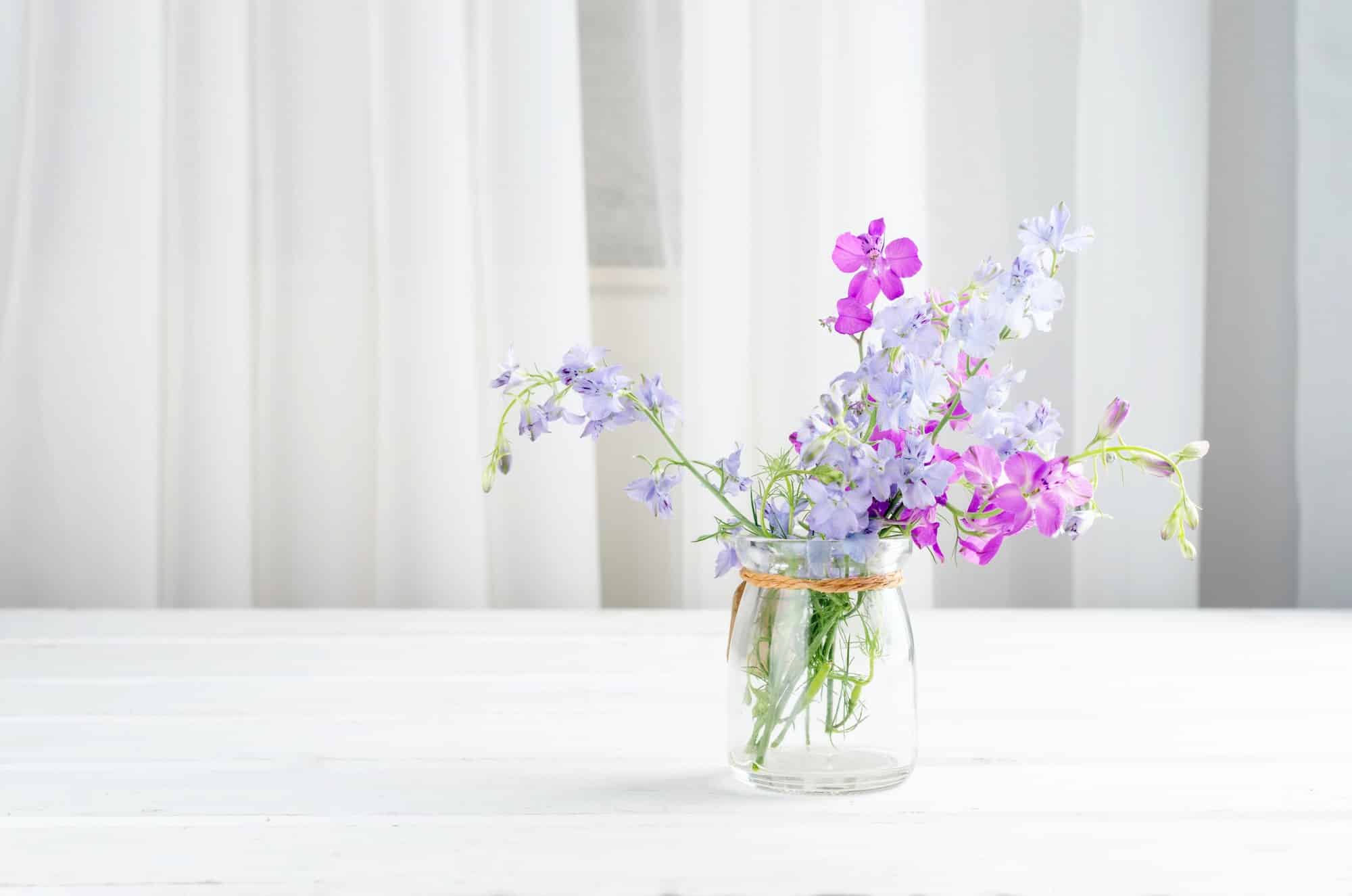 Bouquet of purple lupine flowers in a glass vase table